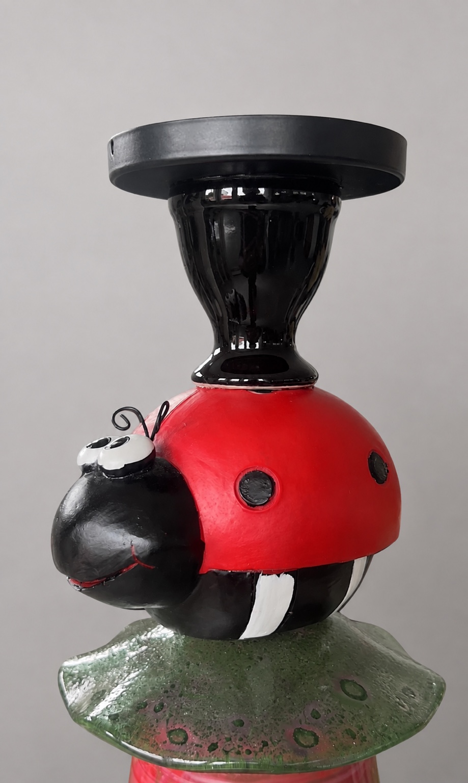 Close-up of the beetle figure and its glass setting