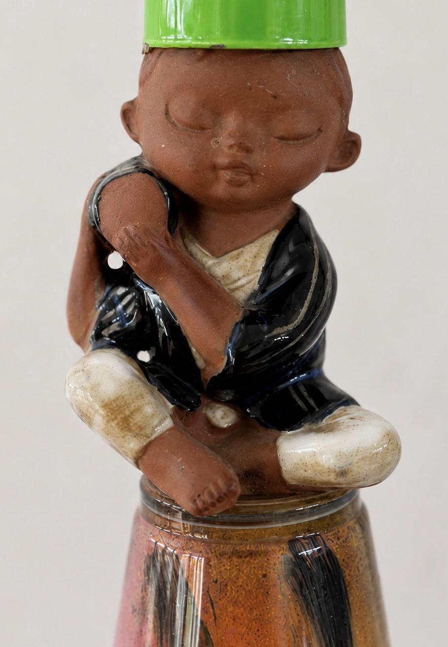 Close view of the seated boy holding a drum
