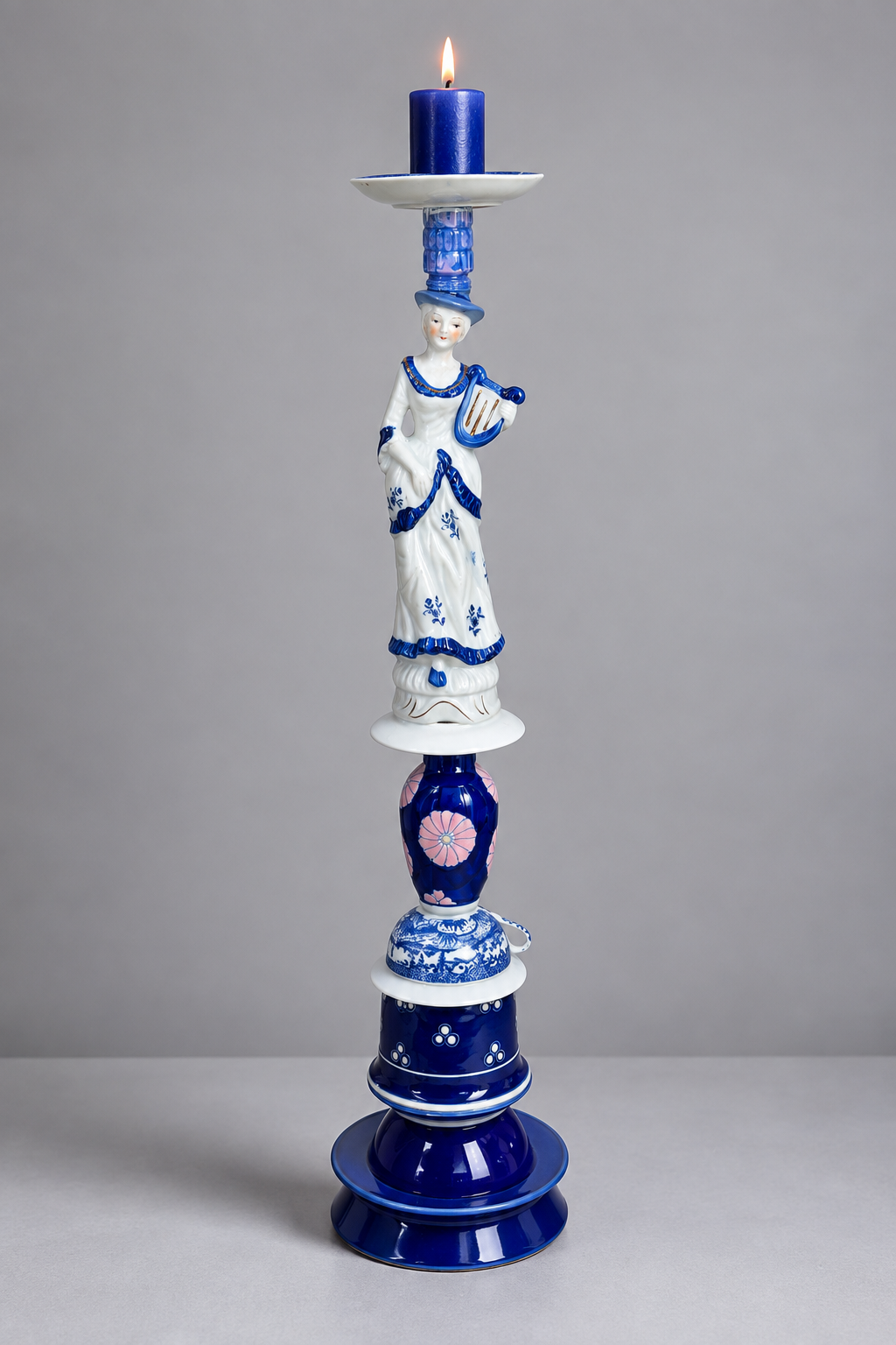 Tall blue-and-white assemblage candleholder with a porcelain muse holding a lyre