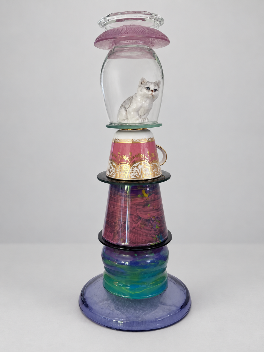 Porcelain cat within stacked glass candleholder, shown without candle