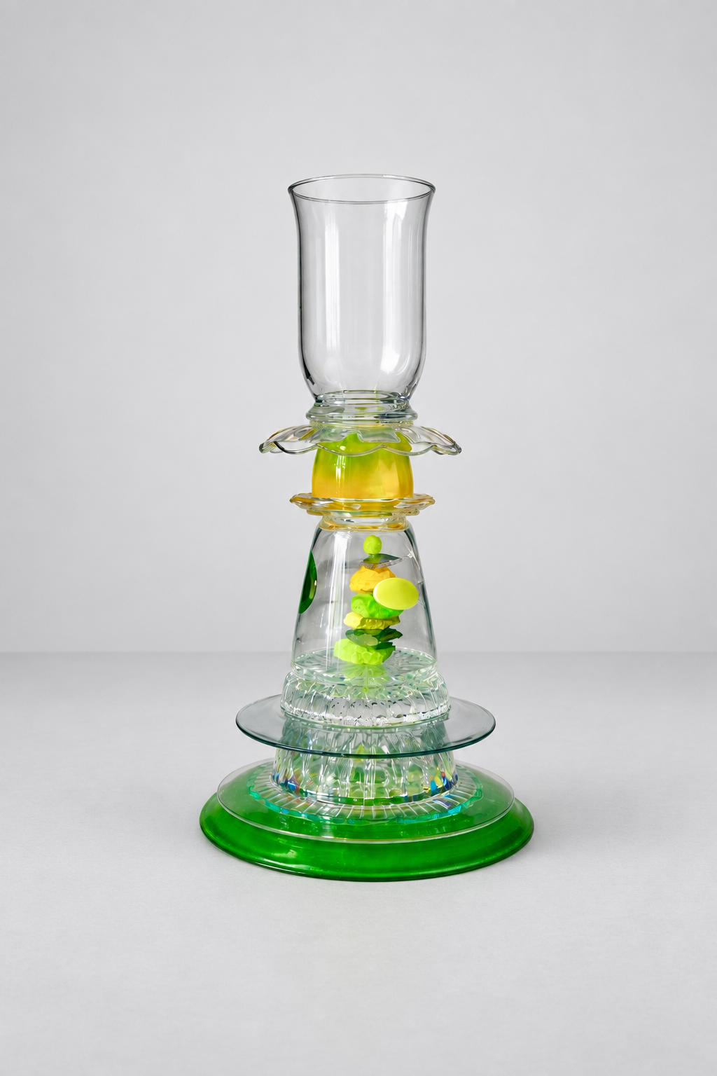 Green, yellow and clear-glass functional assemblage with painted rocks beneath glass