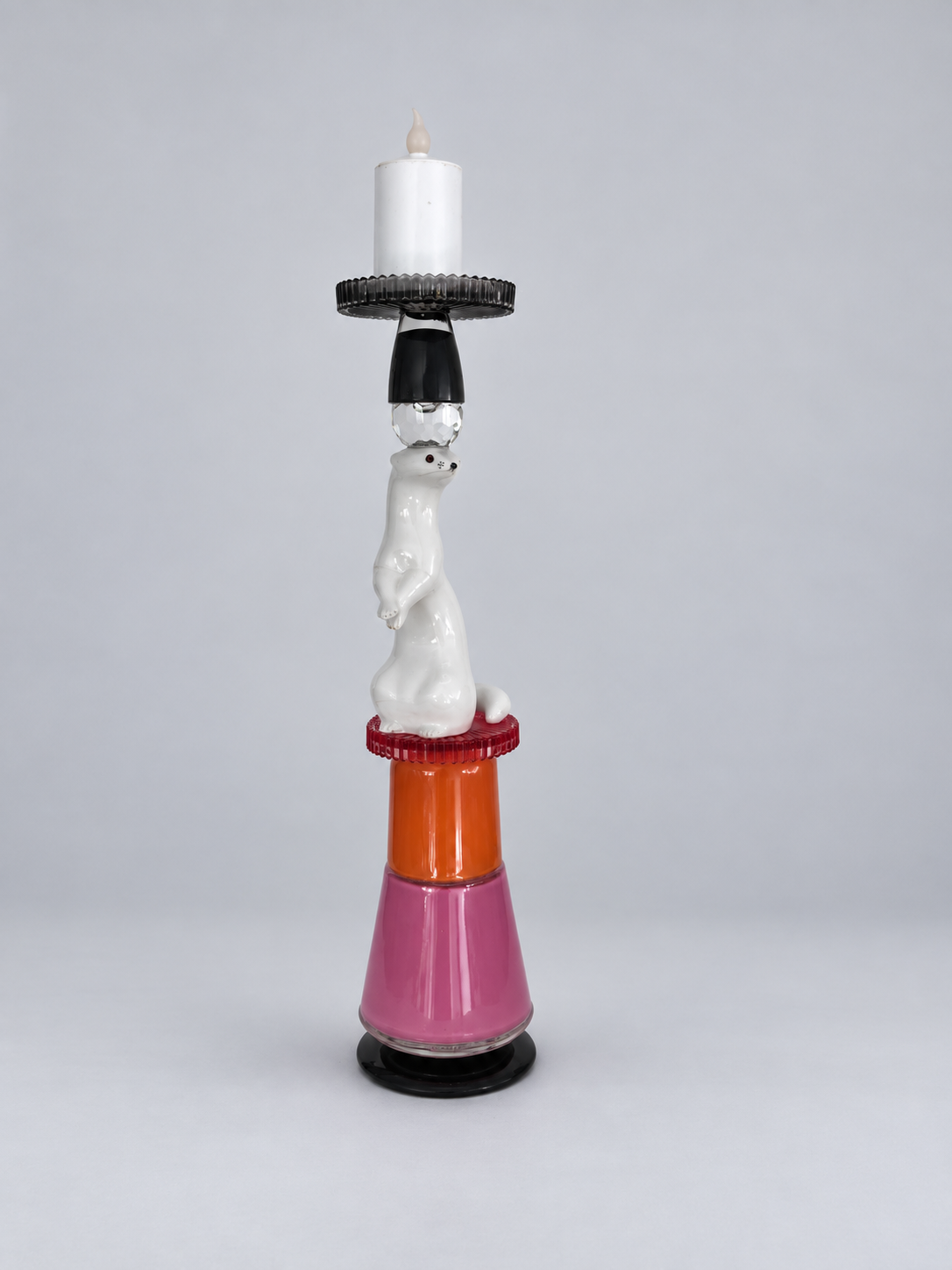 Complete marten candleholder with unlit candle on a pale grey background