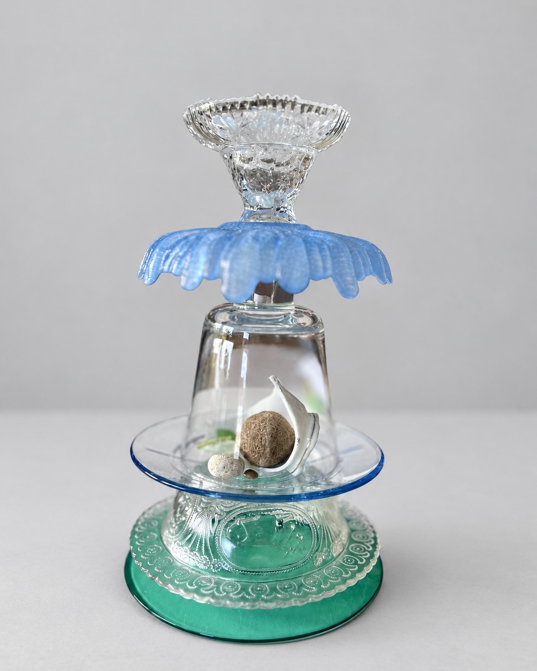 Blue and green glass Neptune ball candleholder, shown without candle