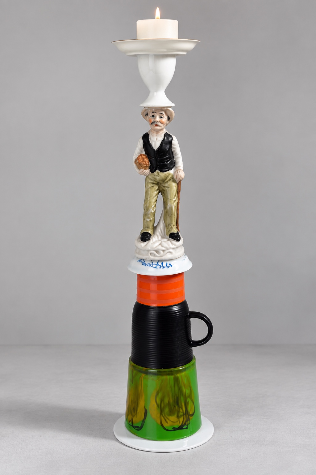 Old man candleholder with a lit candle