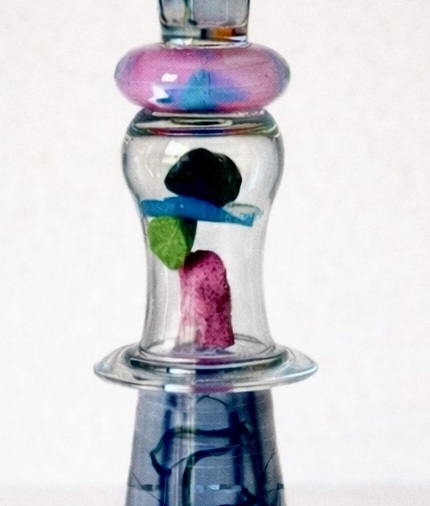 Close-up of the pink, blue and green rocks inside the glass chamber